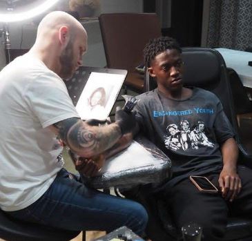 Kobbie Mainoo getting his mother Abena Herold face tattooed on his forearm